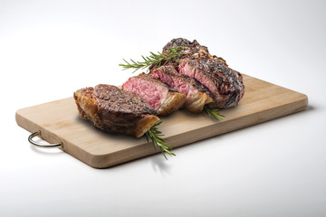 Fiorentina T-bone steak cut on rectangular wooden chopping board