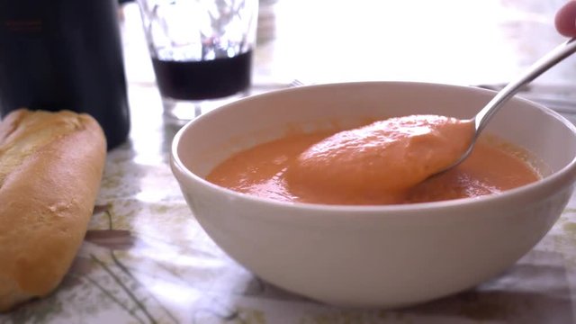 Eating fresh and tasty bowl of Gazpacho.Typical summer cold soup of raw blended vegetables,classic of spanish cuisine.Include tomato, cucumber, bell pepper, onion and garlic, olive oil, wine vinegar.