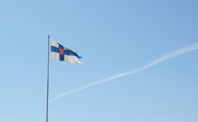 State flag of Finland flies from a flagpole