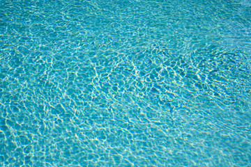 Fototapeta na wymiar Textured sunlight on the ripples of a swimming pool