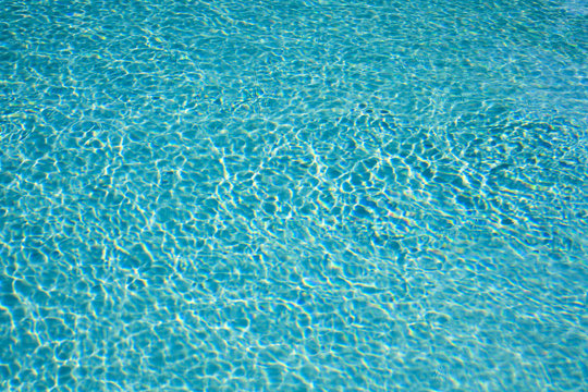 Textured sunlight on the ripples of a swimming pool