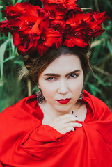 Gorgeous brunette woman with flower wreath, covered in red shawl