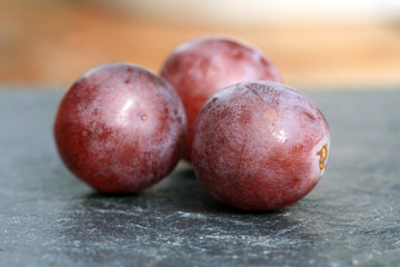 Bunch of grapes on a wooden table an old, country house. An element of outdoor decoration on the occasion of a harvest festival at the end of summer.