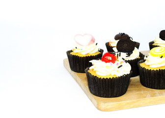 Close up of tasty cup cake on wood board on white backgrounds