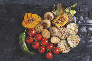 vegetable grilled tomatoes pepper paprika corn potatoes mushrooms on charcoal