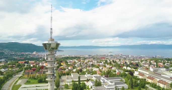 Flying by the Tyholttower and revealing the city of Trondheim