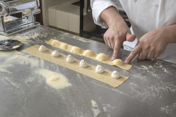 Closing individual Ravioli with stuffing. Preparing freshly made Raviolis with Mascarpone cheese
