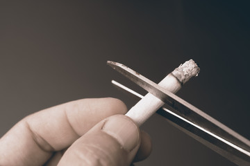 cut cigarette by scissor ,dangeruous to lung,smoking quit concept.