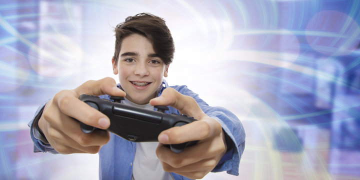 young man playing with the joystick of video games