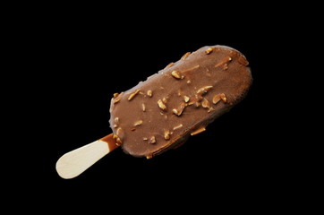 Chocolate ice lolly with almonds on the black isolated background. Ice cream bar,summer hot day....