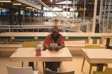 Maasai man in traditional clothing using digital tablet