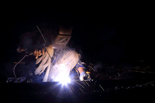 welder worker welding metal construction
