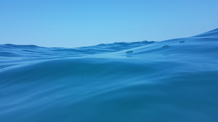 sea surface waves diving blue sea