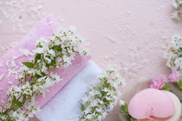 SPA, bath and shower accessories, towel and fresh flowers. Photos in pink colors. Copy space.