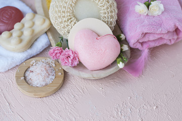 SPA and bathroom accessories. Photo in pink colors. Live flowers and soap. RELAX. Copy space. Flat lay.
