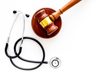 Medical law, health law concept. Gavel and stethoscope on white backgound top view copy space