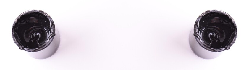 Black the Color Isolated. Open, full bin of black paint. White background