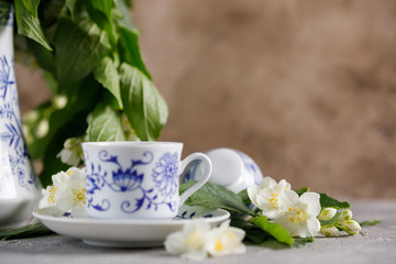 Still life with a tea set and jasmine flowers.