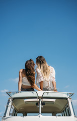 Obraz premium Two lesbian women kissing in the old van