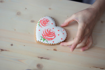 confectioner in a blue apron on a light background with a cake
