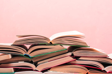 Open book, stack of hardback books. Back to school. Copy space.