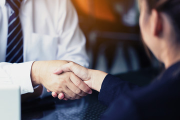 Businessman join hands to deepen relationships after successful negotiations.