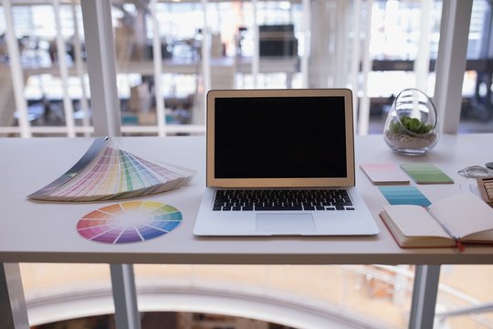 Laptop and color swatch at desk