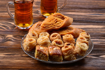Turkish sweet baklava on plate with Turkish tea.