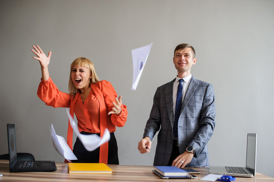 A Business Woman And Man Throwing Papers Up