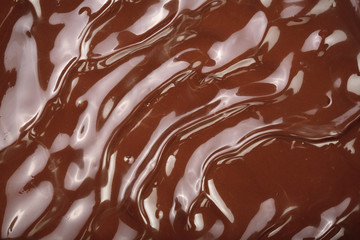 Melted chocolate swirl as a background closeup