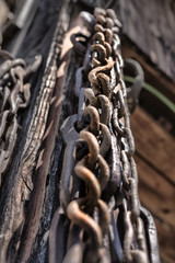 Lot of old, ruined lever chains hanging near a shed in Csernat, transylvani, Romania