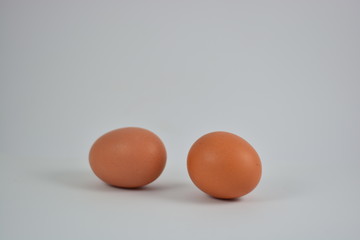 Two chicken eggs on a white background