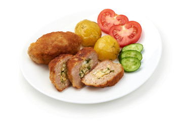 Cutlets cordon bleu with potatoes, tomatoes and cucumbers, isolated on white background.