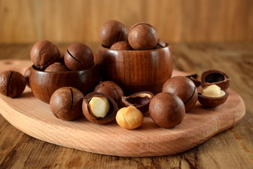 Macadamia nuts against the wooden background