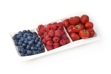 A mixed arrangement. Assorted berries including blueberries, raspberries and strawberry, isolated on white background.