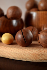 Macadamia nuts against the wooden background