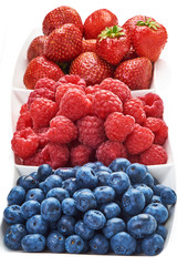 A mixed arrangement. Assorted berries including blueberries, raspberries and strawberry, isolated on white background. Close-up.