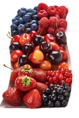 A mixed arrangement. Assorted berries including strawberry, cherry, blueberries, raspberries, black currant and red currant, isolated on white background. Top view.