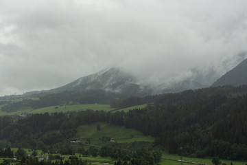 Fototapeta na wymiar Dark and moody clouded valley in Austrian Alps
