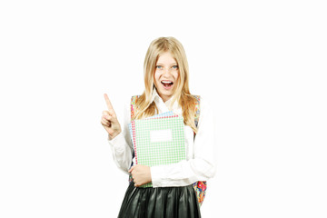 Fototapeta premium Close up portrait of young beautiful happy teenage school girl smiling wide, perfect teeth, standing on white background looking pointing up with index finger. Back to school sale concept. Copy space.