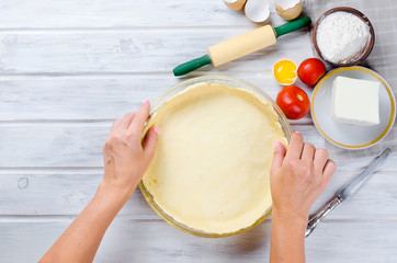 raw base of pastry for baking in a baking dish