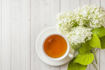 Cup of tea on the table with flowers. Morning cozy Breakfast. Copy space