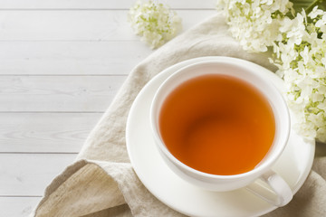 Cup of tea on the table with flowers. Morning cozy Breakfast. Copy space