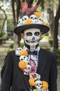 Stylish dude dressed as skeleton. Make-up for the Day of the death celebration in Mexico