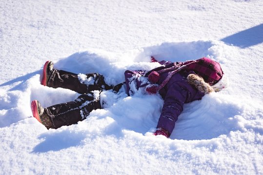 Carefree girl playing in snow
