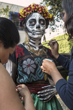 Traditional clothing and make-up for the Day of the dead. Getting ready for the death celebration in Mexico