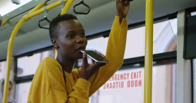 Woman talking on mobile phone while travelling in bus 4k