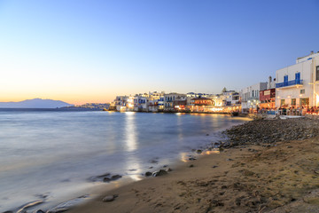 Fototapeta na wymiar Little venice from beach in old town part of Mykonos, Greece during sunset
