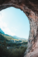 A girl climbs the rock.
