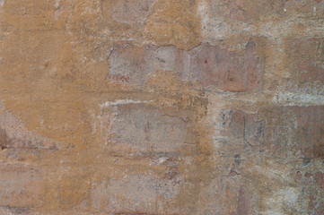 brick wall with the contaminants of yellow paint